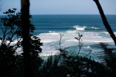 Nick Smart rides a large wave at a reef break in the Catlins, Southland, New Zealand. 