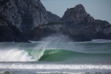 A solid wave peels off at a secluded beach break in the Catlins, Otago, New Zealand. 