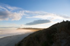 Cristian plays his flute as the sun sets over St Kilda Beach, Dunedin, New Zealand. 