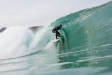 Luke Murphy rides a small glassy barrel on a wave at Blackhead Beach, Dunedin, New Zealand. 