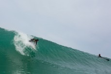 Maz Quinn takes off on a wave at Blackhead Beach, Dunedin, New Zealand. 