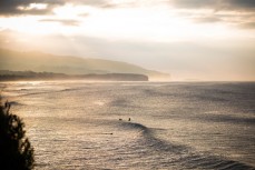 Surfers wait for waves at St Clair Beach, Dunedin, New Zealand. 