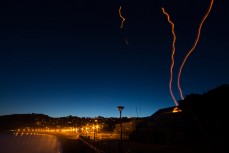 Light trails from lanterns rise into the sky from St Clair Surf Lifesaving Club at St Clair Beach, Dunedin, New Zealand. 