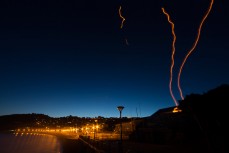 Light trails from lanterns rise into the sky from St Clair Surf Lifesaving Club at St Clair Beach, Dunedin, New Zealand. 