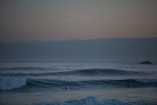 A surfers make the most of late evening light on St Clair Beach, Dunedin, New Zealand. 