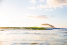 Surfers revel in waves produced from a southeast ground swell at Mount Maunganui, Bay of Plenty, New Zealand. 