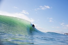 A surfer revels in waves produced from a southeast ground swell at Mount Maunganui, Bay of Plenty, New Zealand. 