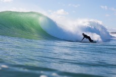 A surfer bottom turns into a nice face on this wave produced from a southeast ground swell at Mount Maunganui, Bay of Plenty, New Zealand. 