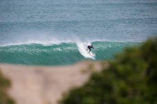 A surfer takes off at Blackhead Beach, Dunedin, New Zealand. 