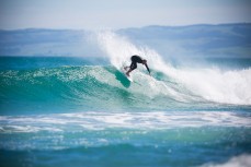 Richard Ayson cranks a turn in playful surf at Blackhead Beach, Dunedin, New Zealand. 