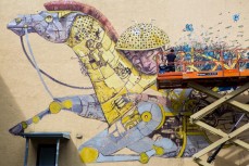 European street artist Pixel Pancho works on a new artwork on a city wall in Dunedin, New Zealand. 