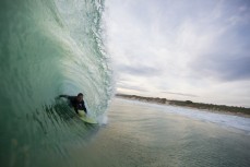 Angus Murray weaves through an open barrel at St Kilda Beach, Dunedin, New Zealand. 