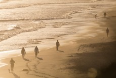People walk on the beach at St Kilda, Dunedin, New Zealand. 