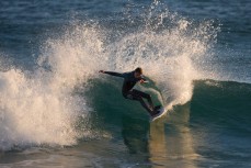A surfer turns on a wave at St Kilda, Dunedin, New Zealand. 