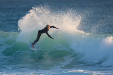 Surfer girl Hayley Coakes turns on a wave at St Kilda, Dunedin, New Zealand. 