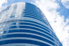 A glass building reflects the clouds near the CBD, Wellington, New Zealand. 