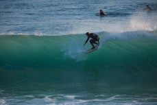 A surfer rides a wave at St Kilda, Dunedin, New Zealand. 