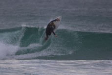JC Susan rides a wave at St Kilda, Dunedin, New Zealand. 
