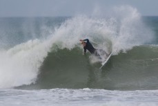 JC Susan carves on a wave at Aramoana Beach, Dunedin, New Zealand. 