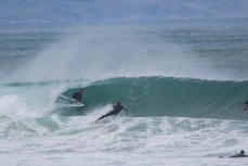 A surfer rides a barrel at Aramoana Beach, Dunedin, New Zealand. 