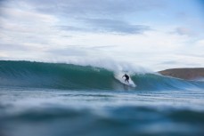 Nigel Bryce drops into a wave at Aramoana Beach, Dunedin, New Zealand. 