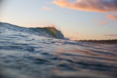 A peak backlit by sunrise in a swell produced from a southeast ground swell at Mount Maunganui, Bay of Plenty, New Zealand. 