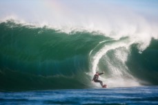 Tom Bracegirdle attacks a slabbing wave on his backhand at a remote reef break near Dunedin, New Zealand. 