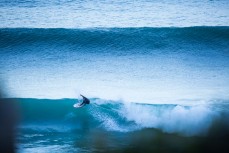 A surfer turns on a fun waves at Aramoana, Dunedin, New Zealand. 