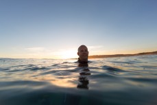 Paul Thompson swims in the surf at St Kilda Beach, Dunedin, New Zealand. 