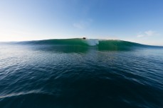 Josh Jenkins takes off on wave of the day at Blackhead Beach, Dunedin, New Zealand. 