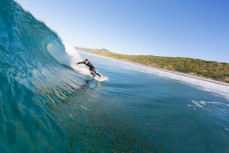 A surfer lines up a section at Blackhead Beach, Dunedin, New Zealand. 
