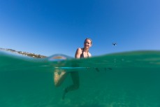 Sophie Luther surfing in summer at St Clair Beach, Dunedin, New Zealand. 