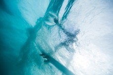 A surfer places their hand in the wall on a hollow wave at Blackhead Beach, Dunedin, New Zealand. 