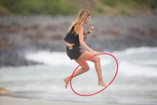 Hula hoop girl Simone Engels leaps at Blackhead Beach, Dunedin, New Zealand. 