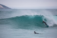 Skep rides a wave at Blackhead Beach, Dunedin, New Zealand. 