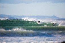 Surfers make the most of a fresh ground swell at Whareakeake, Dunedin, New Zealand. 