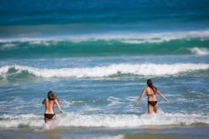 Molly McPhail (left) and Toni Shields enjoy the early autumn weather at St Kilda Beach, Dunedin, New Zealand. 