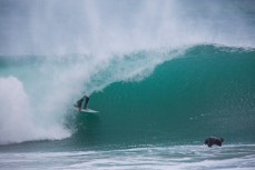 Jamie Civil drives deep in the barrel during cyclone Pam at Aramoana Beach, Dunedin, New Zealand. 