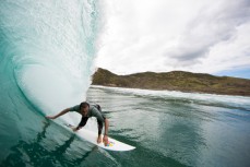 Brett Wood lines up a barrel in a new swell on a beach near Raglan, New Zealand. 