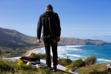 Jack Lynch contemplates a surf on Otago Peninsula, Dunedin, New Zealand. 