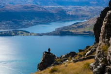 Philip Rive finds a vantage point during the autumn muster of the lake face at Cecil Peak Station, Queenstown, Central Otago, New Zealand. 
