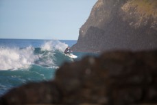 A surfer rides a wave at St Clair Beach, Dunedin, New Zealand. 