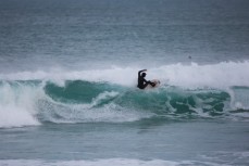A surfer rides the lip of a wave at Blackhead Beach, Dunedin, New Zealand. 