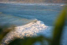 Whitewater boils as a wave wraps into Manu Bay, Raglan, Waikato, New Zealand. 