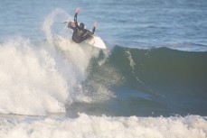 Luke Grubb airs on a wave at Blackhead Beach, Dunedin, New Zealand. 