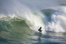 Luke Grubb drops into a big wave at Blackhead Beach, Dunedin, New Zealand. 