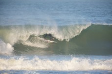 Tom Bracegirdle rides a barrel at dawn in fun surf at Blackhead Beach, Dunedin, New Zealand. 