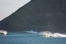 A surfer rides a set wave through St Clair Point, Dunedin, New Zealand. 