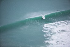A surfer takes off on a wave shortly after the offshore arrived at Aramoana, Dunedin, New Zealand. 