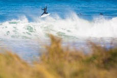A surfer airs the end section in a clean winter swell at St Kilda beach, Dunedin, New Zealand. 